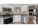 Bright kitchen featuring white cabinetry, stainless steel appliances and functional layout at 425 Hidden Cellars Dr, Holly Springs, NC 27540