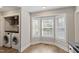 Bright laundry room with modern washer and dryer set next to bay window at 425 Hidden Cellars Dr, Holly Springs, NC 27540