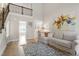 Open-concept living room with wood floors, stairs, and a view into the dining area at 425 Hidden Cellars Dr, Holly Springs, NC 27540