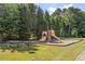 A playground with play equipment, picnic table, and grill, set in a grassy area with mature trees at 425 Hidden Cellars Dr, Holly Springs, NC 27540