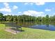 A serene pond view with a bench, surrounded by lush greenery and a clear sky at 425 Hidden Cellars Dr, Holly Springs, NC 27540