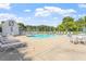 Bright community pool with ample lounge chairs and tables, perfect for relaxation and social gatherings at 425 Hidden Cellars Dr, Holly Springs, NC 27540