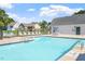 Community swimming pool area with clear blue water, lounge chairs, and views of nearby homes at 425 Hidden Cellars Dr, Holly Springs, NC 27540