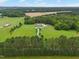 Picturesque estate featuring a lovely home with a long driveway, set amidst sprawling fields, lush trees, and a pond at 4737 Uzzle Rd, Rougemont, NC 27572