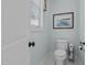 Powder room with a white toilet, classic fixtures, and nautical-themed decor at 4737 Uzzle Rd, Rougemont, NC 27572