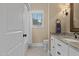Bathroom featuring a white vanity with granite countertops, and a window at 4737 Uzzle Rd, Rougemont, NC 27572