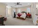 Large bedroom with exercise equipment, windows, and neutral carpeting at 4737 Uzzle Rd, Rougemont, NC 27572