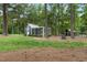 Spacious chicken coop with outdoor run surrounded by a lush lawn at 4737 Uzzle Rd, Rougemont, NC 27572