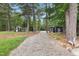 Chicken coop at the end of a gravel drive surrounded by mature trees at 4737 Uzzle Rd, Rougemont, NC 27572