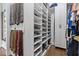 Bright walk-in closet showcasing custom shelves and compartments for shoes and accessories at 4737 Uzzle Rd, Rougemont, NC 27572