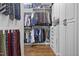 Spacious walk-in closet featuring custom shelving, storage, and wood flooring at 4737 Uzzle Rd, Rougemont, NC 27572