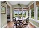 Dining area with large windows and a round wooden table with seating for four at 4737 Uzzle Rd, Rougemont, NC 27572