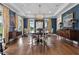 Elegant dining room with blue walls, chandelier, and large windows at 4737 Uzzle Rd, Rougemont, NC 27572