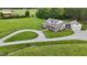 Stunning two-story home with a wraparound porch, well-manicured lawn, and a circular driveway at 4737 Uzzle Rd, Rougemont, NC 27572