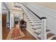 Bright foyer featuring a staircase with white and black accents, and hardwood floors at 4737 Uzzle Rd, Rougemont, NC 27572