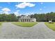 A two-story white home featuring a charming wrap-around porch and a circular driveway at 4737 Uzzle Rd, Rougemont, NC 27572