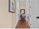 Hallway with wood floors, neutral walls, and classic trim at 4737 Uzzle Rd, Rougemont, NC 27572