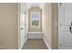 Hallway featuring a window with a bench, doors, and carpet at 4737 Uzzle Rd, Rougemont, NC 27572