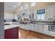Bright kitchen boasting white cabinets, dark countertops, an island, and high-end appliances for culinary enthusiasts at 4737 Uzzle Rd, Rougemont, NC 27572