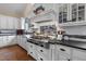 Chef's kitchen featuring white cabinets, stainless steel appliances, a professional range, and stylish backsplash at 4737 Uzzle Rd, Rougemont, NC 27572