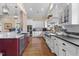 Spacious kitchen with white cabinets, an island with a copper sink, and professional-grade appliances for cooking at 4737 Uzzle Rd, Rougemont, NC 27572