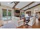 Expansive living room with stone fireplace, vaulted ceilings, and outdoor access to the inviting pool area at 4737 Uzzle Rd, Rougemont, NC 27572