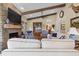 Comfortable living room with stone fireplace, exposed beams, and stylish decor creating an inviting space at 4737 Uzzle Rd, Rougemont, NC 27572