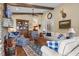 Cozy living room with exposed beams, stone fireplace, and stylish furnishings offers a warm and inviting atmosphere at 4737 Uzzle Rd, Rougemont, NC 27572