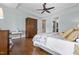 Main bedroom with hardwood floors, tray ceilings, and a seating area at 4737 Uzzle Rd, Rougemont, NC 27572