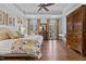 Bright main bedroom featuring hardwood floors, tray ceilings, and double doors leading to a balcony at 4737 Uzzle Rd, Rougemont, NC 27572