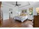 Main bedroom with hardwood floors, tray ceilings, and neutral-colored walls at 4737 Uzzle Rd, Rougemont, NC 27572