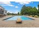 Inviting in-ground pool with a stone feature, brick patio, and a picturesque view of the backyard at 4737 Uzzle Rd, Rougemont, NC 27572