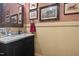 Stylish powder room with vanity, granite countertop, and decorative wallpaper at 4737 Uzzle Rd, Rougemont, NC 27572