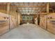 Spacious barn interior with wooden stalls, open design, and natural light creating a welcoming space at 4737 Uzzle Rd, Rougemont, NC 27572