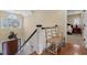 Foyer staircase featuring hardwood floors and a charming decorative sitting bench at 4737 Uzzle Rd, Rougemont, NC 27572