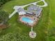 Beautiful aerial view showcasing a large home with a pool, patio area, and a cozy fire pit in the backyard at 4737 Uzzle Rd, Rougemont, NC 27572