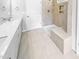 Bathroom with double sink vanity, white cabinets, neutral tile flooring, and a tiled walk-in shower with bench at 477 Beacon Hill Rd # 29, Lillington, NC 27546