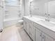 Bright bathroom featuring double sinks, modern fixtures, tub-shower combo, and neutral tile floors at 477 Beacon Hill Rd # 29, Lillington, NC 27546