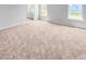 Spacious bedroom with carpeted floors, walk-in closet, and windows for natural light at 477 Beacon Hill Rd # 29, Lillington, NC 27546