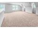 Large bonus room with neutral carpet, light gray walls, white trim, and multiple windows offering natural light at 477 Beacon Hill Rd # 29, Lillington, NC 27546