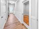 Bright hallway with beautiful wood flooring and white trim and doors, offering seamless access to the rooms at 477 Beacon Hill Rd # 29, Lillington, NC 27546