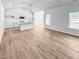 Open-concept living room showcasing wood-look floors and ample natural light at 477 Beacon Hill Rd # 29, Lillington, NC 27546