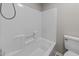 Bathroom tub and tile, paired with wood-look flooring and a white toilet at 5012 Silverdene St, Raleigh, NC 27616
