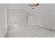 Spacious bedroom featuring neutral walls, plush carpeting, ceiling fan and multiple doorways at 5012 Silverdene St, Raleigh, NC 27616