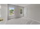 Bright bedroom featuring large windows and neutral carpet at 5012 Silverdene St, Raleigh, NC 27616