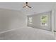 Bright bedroom featuring neutral walls, plush carpeting, two windows and a ceiling fan at 5012 Silverdene St, Raleigh, NC 27616