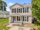 Inviting two-story home featuring black shutters and a cozy front porch at 5012 Silverdene St, Raleigh, NC 27616