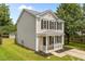 Charming two-story home featuring vertical siding, dark shutters, and a cozy front porch at 5012 Silverdene St, Raleigh, NC 27616