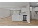Bright kitchen area features white cabinets, a stainless steel dishwasher, and wood-look flooring at 5012 Silverdene St, Raleigh, NC 27616
