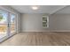 Living room featuring wood floors and double glass doors to outdoor deck at 5012 Silverdene St, Raleigh, NC 27616